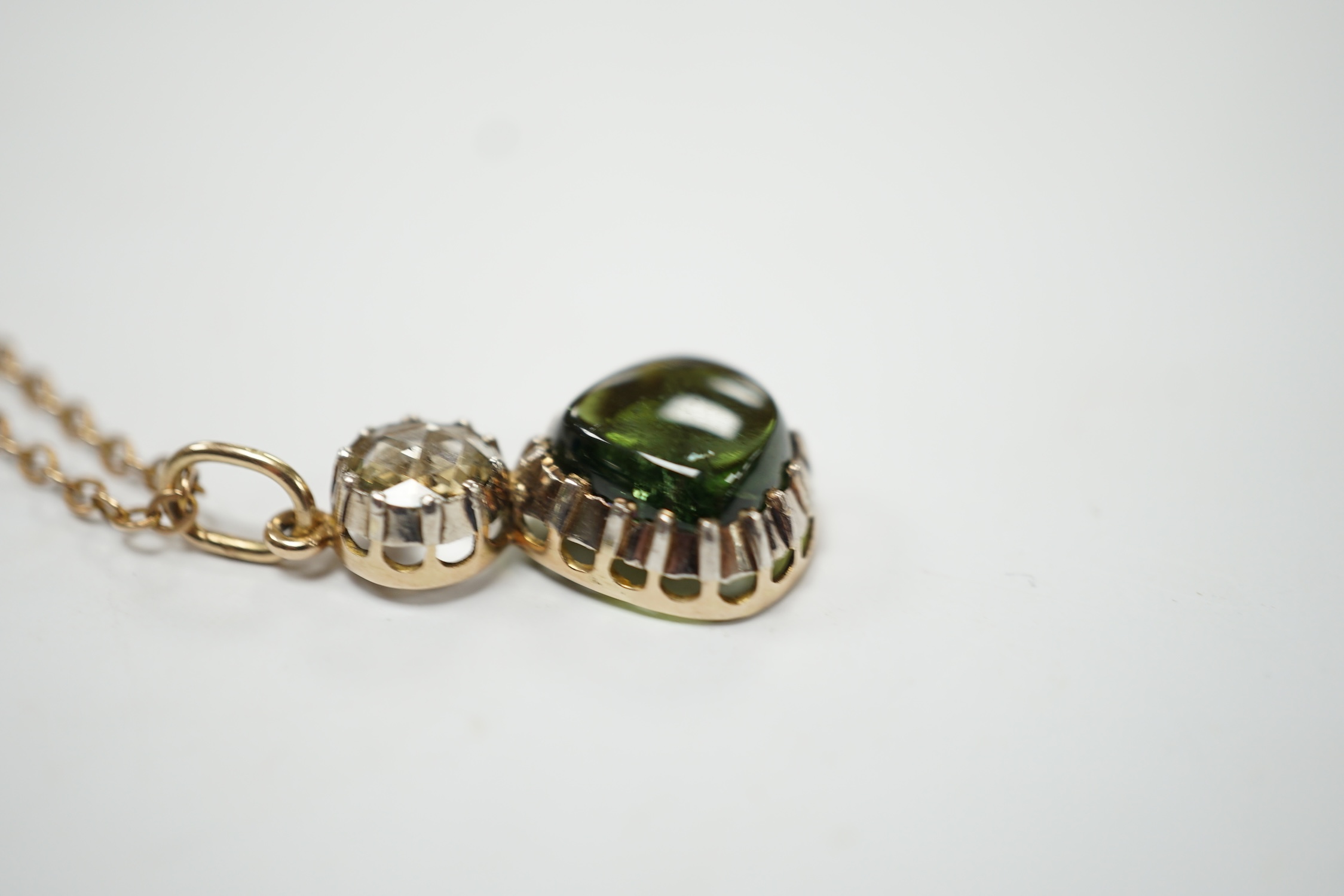 A Georgian yellow and white metal, rose cut diamond and shaped cabochon green tourmaline set pendant, 24mm, on a yellow metal chain, 48cm, gross weight 5.8 grams. Fair condition.